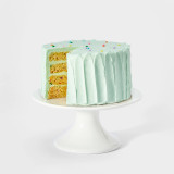 Image 1: Celebration 4-layer cake on a white background with a slice cut out showing the confetti baked into the vanilla cake and the SusieBlue (light blue) buttercream