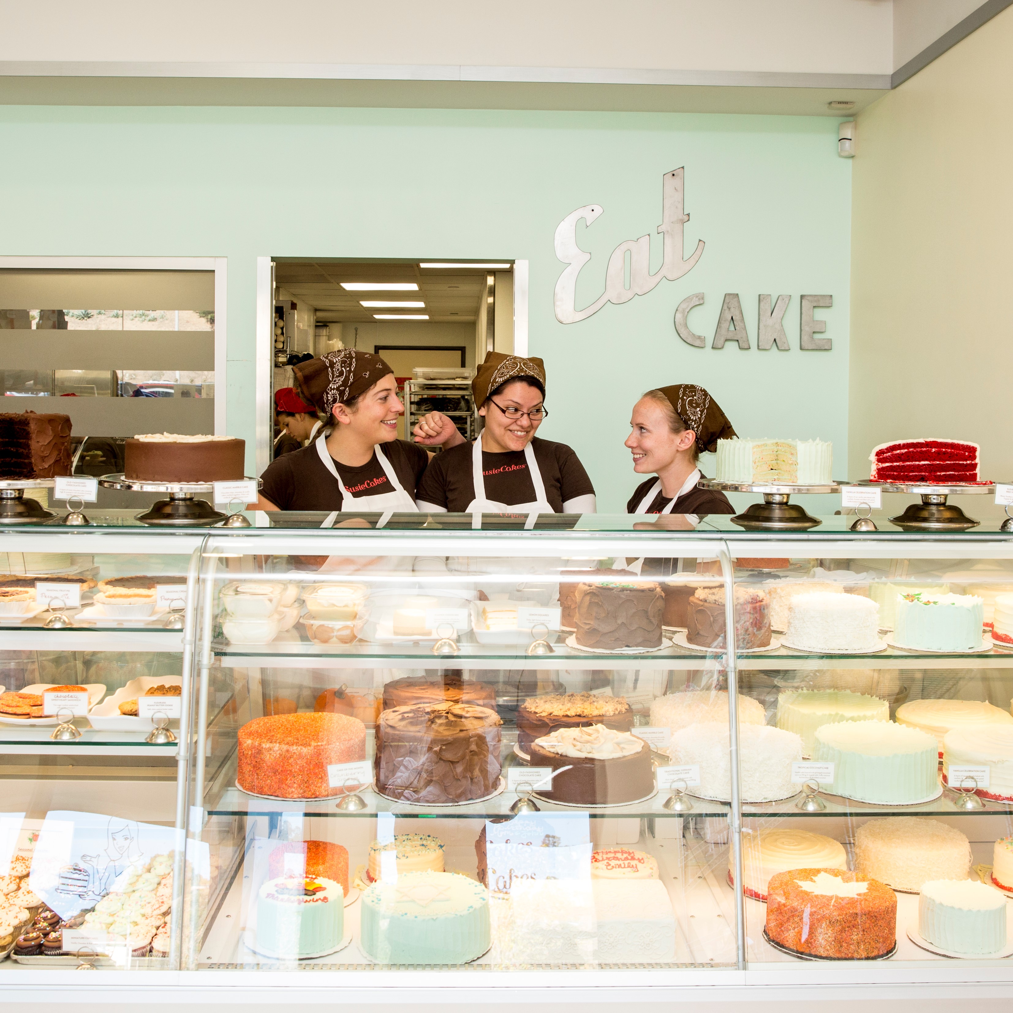 Coworkers chatting and laughing in a bakery