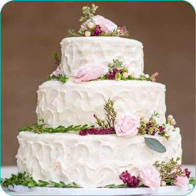 Three tier white wedding cake with flowers
